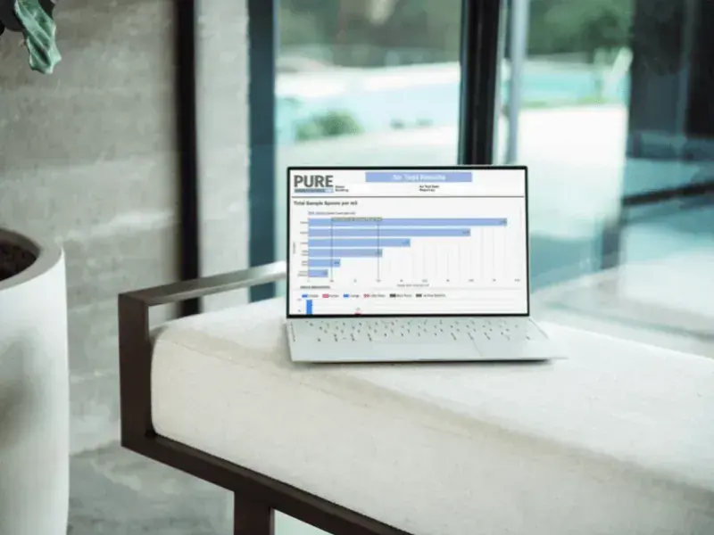 A laptop showing a before-and-after air test dashboard