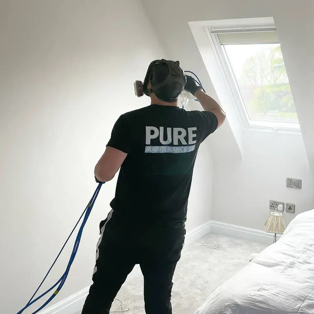 A technician applying EverPURE in a loft bedroom